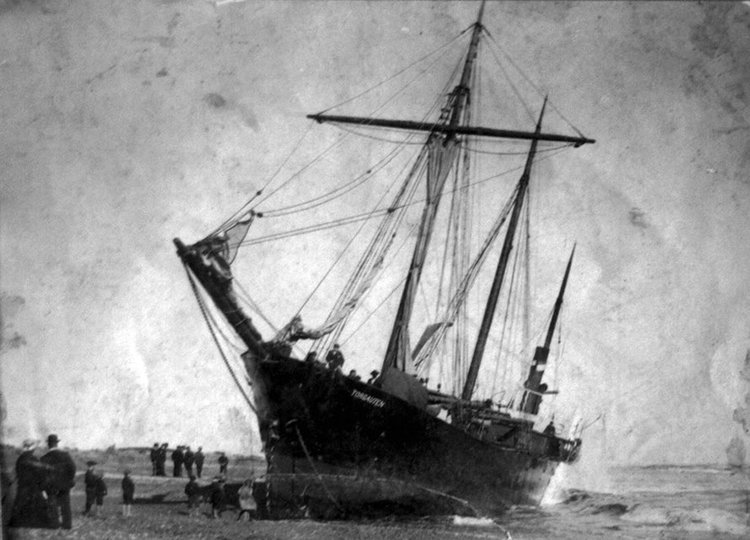 The steamer, Torgauten, stuck fast on the Hokitika bar in 1904. She was refloated two months after having grounded through a fouled propeller (Image courtesy Hokitika Museum)